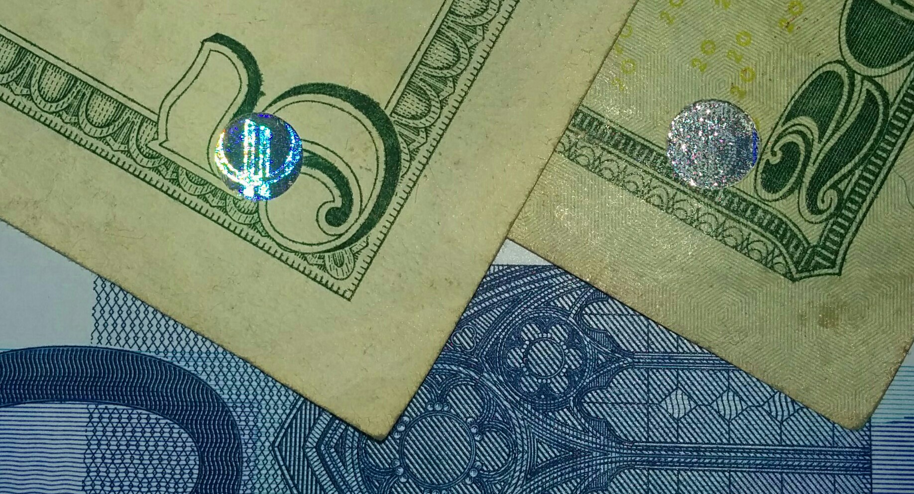 These two bills have the holes in the same position like having been made together.